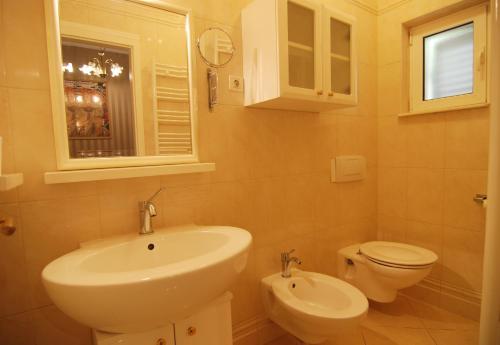 a bathroom with a sink and a toilet at Villa Artpalathos in Kaštela