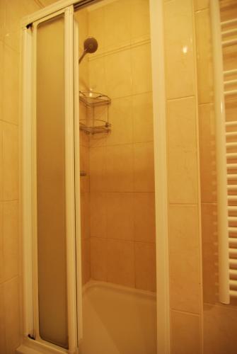 a shower with a glass door in a bathroom at Villa Artpalathos in Kaštela