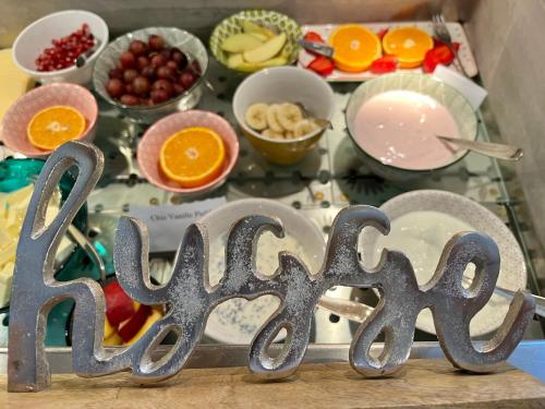 a sign that saysasy in front of a table of food at B&B Apart Hotel Goldener Hahn - Hygge Pool & Sauna in Baiersbronn