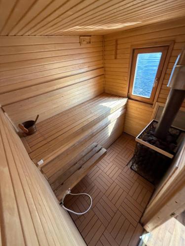 an inside view of a wooden sauna with a bench at Laivu nomas pirts in Ikšķile