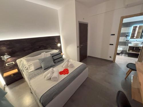 a bedroom with a large bed with towels on it at Metropolitan in La Spezia