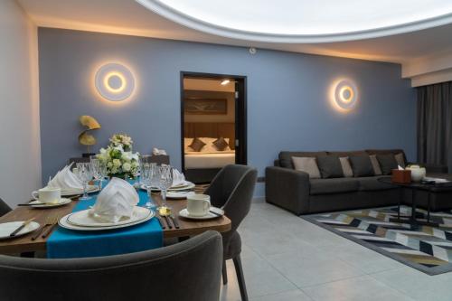 a living room with a table and a couch at Marbella Resort in Sharjah