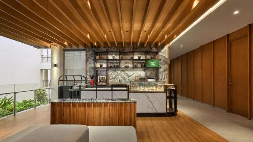 a restaurant with a wooden ceiling and a counter at Holiday Inn Resort Bintan Lagoi Beach by IHG in Lagoi