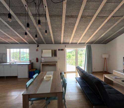 a living room with a wooden table and chairs at Casa do Largo in Figueiró dos Vinhos