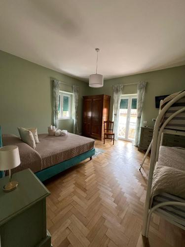 a bedroom with two bunk beds and a wooden floor at Ristorante Paisà. Cibo e Ospitalità in Agnone