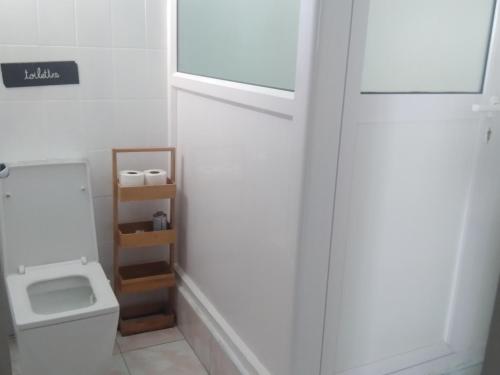 a bathroom with a toilet and a white door at White house in Flic-en-Flac