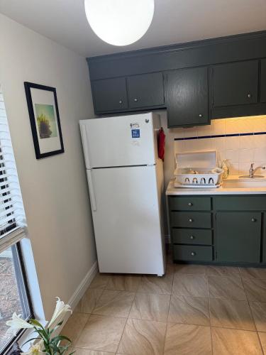 a kitchen with a white refrigerator and a sink at Foothills of the Rockies in Boulder