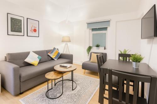 a living room with a couch and a table at Space For Groups, 10 mins from centre with parking! in Cardiff