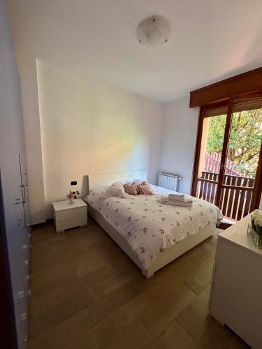 a bedroom with a bed and a large window at Alice Nel Paese Delle Meraviglie in Buccinasco
