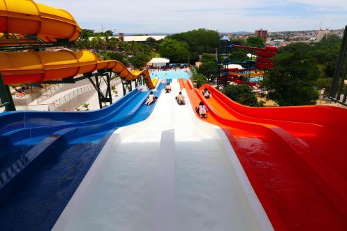 a slide at a water park with people on it at Piazza Diroma Com acesso Gratuito Ao diroma Acqua Park in Caldas Novas