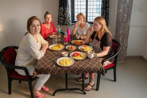 a group of women sitting around a table eating food at Hotel Avon International in Aurangabad
