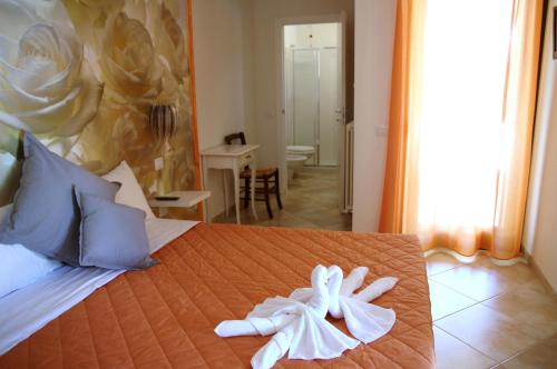 a hotel room with a bed with towels on it at Residence Stella Del Gran Sasso in Colledara
