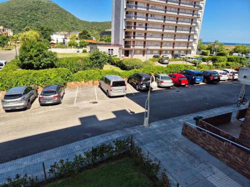 a parking lot with cars parked in a building at Apto en la playa Santoña C05A02 in Santoña