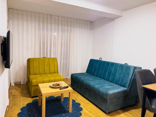 a living room with a couch and a chair at TaNa's Apartments in Donji Štoj