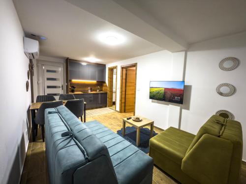 a living room with a couch and a table at TaNa's Apartments in Donji Štoj