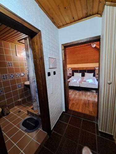a bathroom with a shower and a bedroom at Complex Popangelov in Borovets