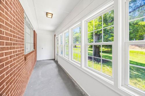 an empty hallway with windows and a brick wall at The Landing Spot in Seneca