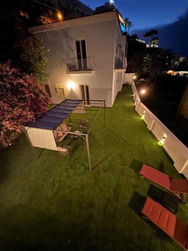 a tennis court in the yard of a house at night at Bella Ischia in Casamicciola Terme