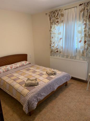 a bedroom with a bed with a pair of shoes on it at Konstantakos Michail 