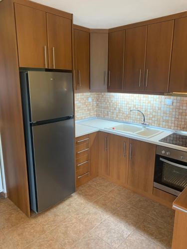 a kitchen with a refrigerator and a sink at Konstantakos Michail 