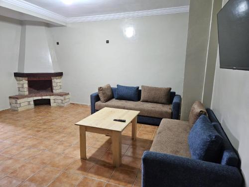 a living room with a couch and a table at Residence Zomroda Sidi Bouzid in Sidi Bouzid