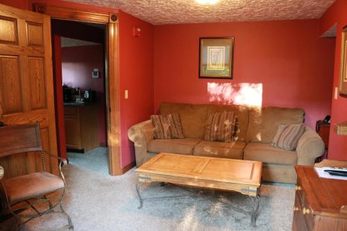 a living room with a couch and a coffee table at Landoll's Mohican Castle in Loudonville