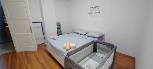 a small bedroom with a bed with two candles on it at Apartman Leon in Rijeka