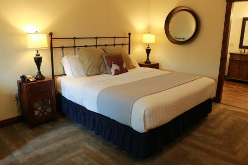 a bedroom with a large bed and a mirror at Landoll's Mohican Castle in Loudonville