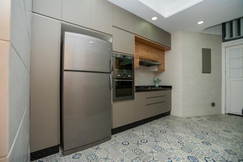 a large kitchen with a stainless steel refrigerator at Hassan Center 3BR Cozy Stay in Rabat