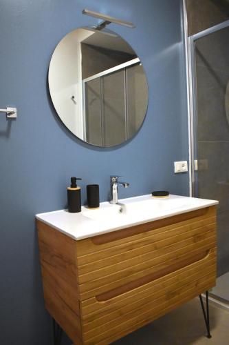 a bathroom with a sink and a mirror at La Casa di Legno in Tortolì