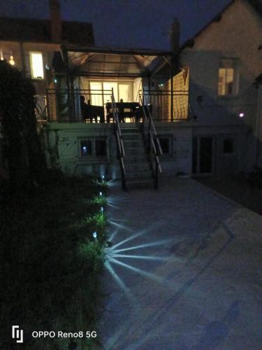 a cat sitting on the porch of a house at night at Escale Secrète Détente Montargis Parking Gratuit in Montargis
