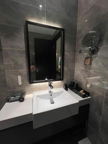 a bathroom with a sink and a mirror at The Saphire Palace by Anna Vũ in Ha Long