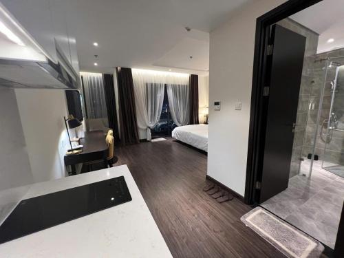 a bathroom with a bed and a shower in a room at The Saphire Palace by Anna Vũ in Ha Long