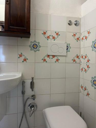 a bathroom with a toilet and a sink at Traditional Eolian House Luna - Unique experience in San Salvatore