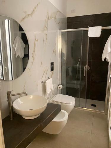 a bathroom with a sink and a toilet and a shower at Hotel Nautic in Lampedusa