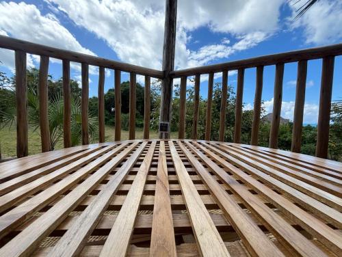 a wooden deck with a view of the mountains at Basecamp Changani in Dar es Salaam