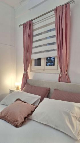 a bedroom with two beds and a window at Magical Dawn from Leonidio to Tyros in Péra Mélana