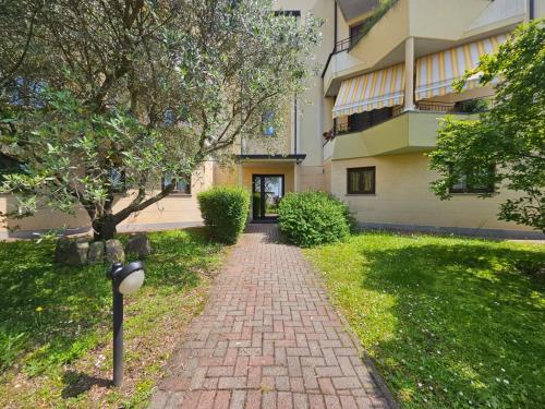 a brick walkway in front of a building at Malpensa Retreat in Ferno