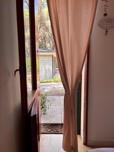 an open door with a curtain in a room at Home C 44 con posto spiaggia in Eraclea Mare