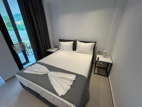a bedroom with a bed and a large window at House Thomi in Skala Potamias