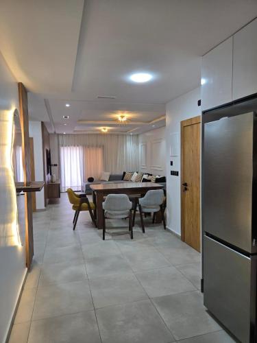 a kitchen and living room with a table and a dining room at Luxury appartment avec piscine à la Marina Saidia in Saidia 