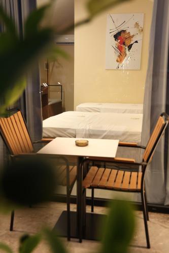 a bedroom with a bed and a table and a chair at Villas Palma Airport in Rinas