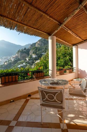 a table and chairs on a balcony with a view at Villa Treville in Positano