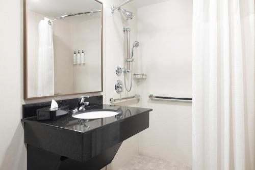 a bathroom with a sink and a shower at Fairfield Inn & Suites – Buffalo Airport in Cheektowaga