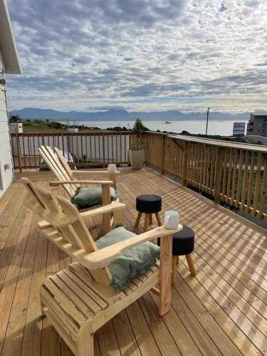 two chairs on a deck with a view of the ocean at Sea and Mountain View in Mossel Bay