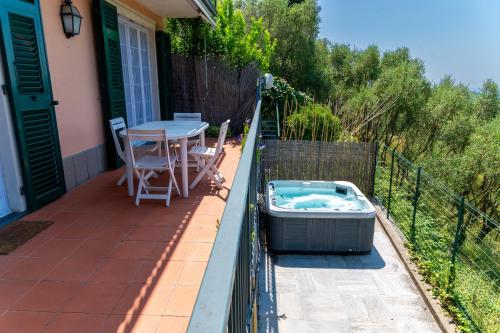 a patio with a table and a tub on a balcony at Ollie`s house in Leivi
