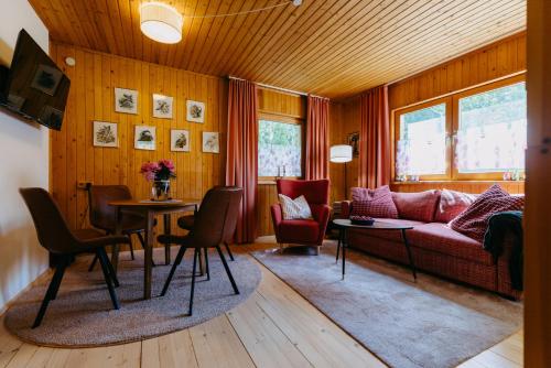 a living room with a couch and a table and chairs at LANDHAUS AnnMarie in Limbach im Burgenland