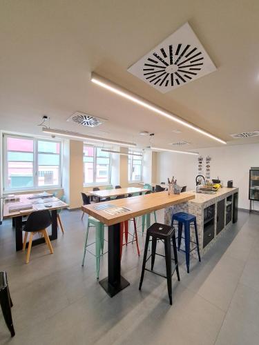 a kitchen with a large table and some chairs at LUMEN ALBERGUE in Mondoñedo