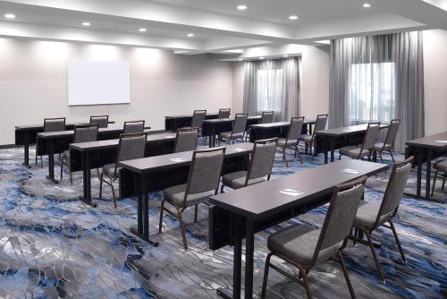 a conference room with tables and chairs and a whiteboard at Fairfield Inn & Suites – Buffalo Airport in Cheektowaga
