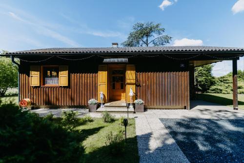 a small house with a black roof at LANDHAUS AnnMarie in Limbach im Burgenland